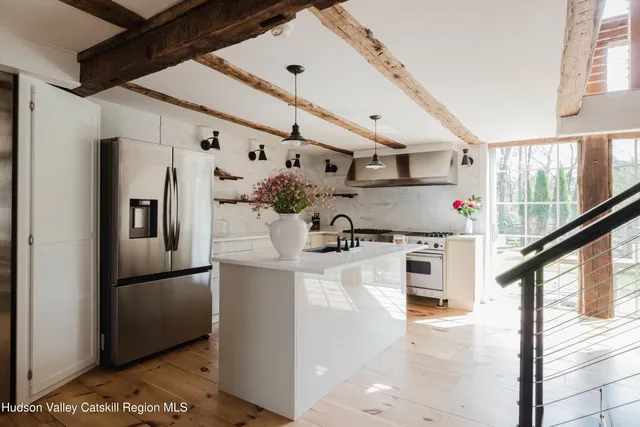 a living room with furniture a rug a fireplace and a large window