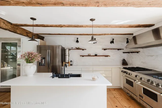 a kitchen with a sink a stove and cabinets