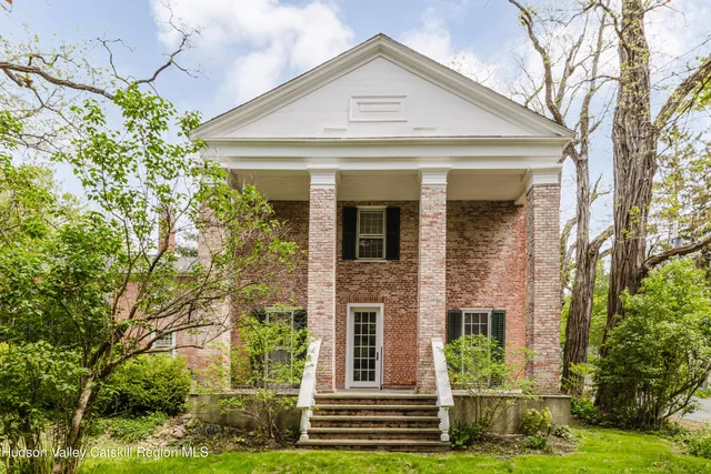a living room with furniture a fireplace and a table