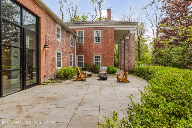 a view of a hallway with front door wooden floor and stairs