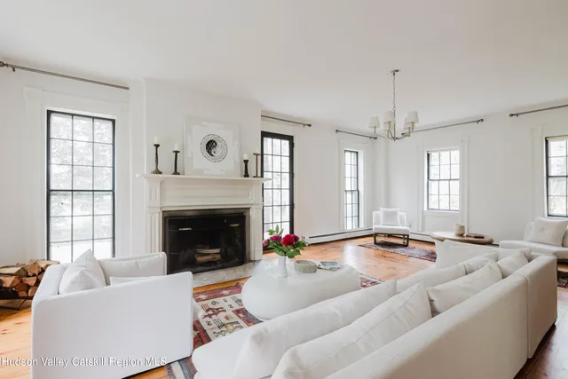 a bathroom with a granite countertop sink and a large mirror