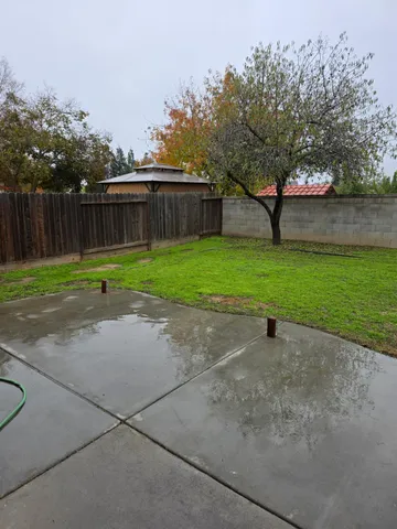 a view of a field with wooden fence