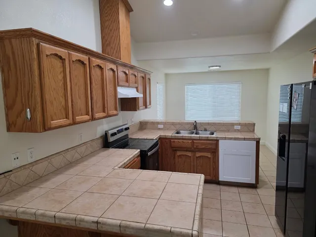 a kitchen with a stove top oven and cabinets