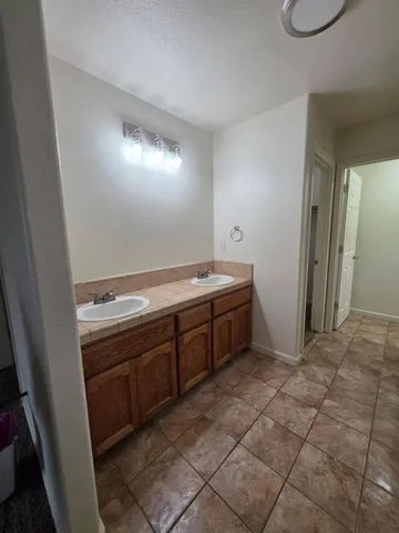 a room with a sink cabinets and utility room