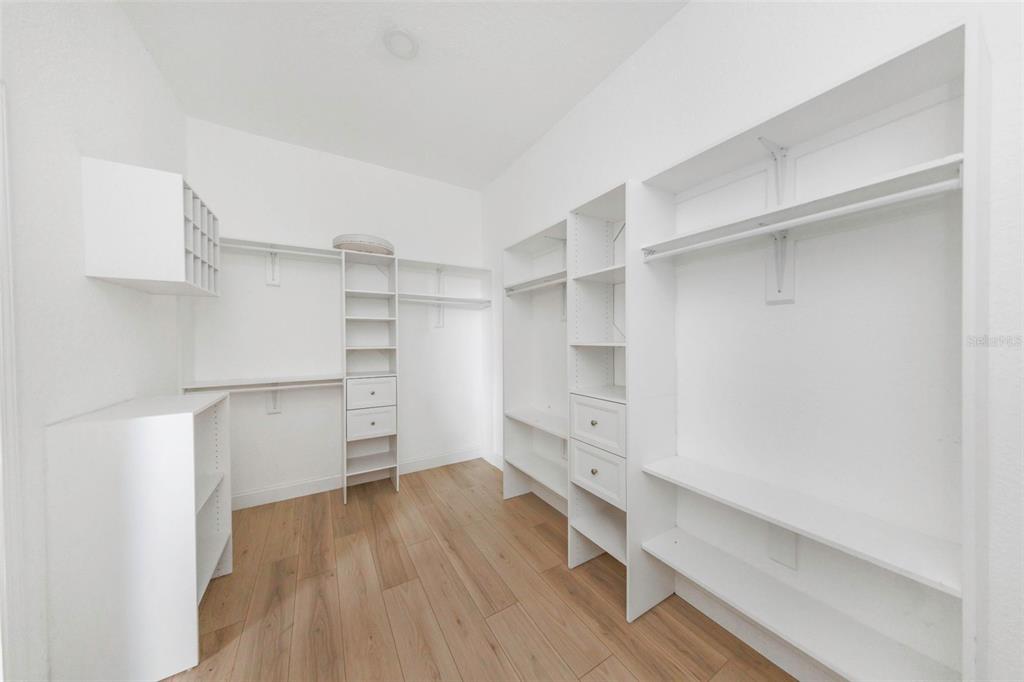 20138 Bowman Road Spring Hill, FL 34610 - Photo 33 of 40 a room with walk in closet and wooden floor