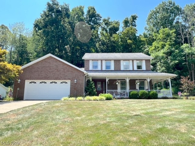 1349 Deer Hill Road Dennison, OH 44621 - Photo 1 of 36 View of front of home featuring a garage, covered porch, and a front yard