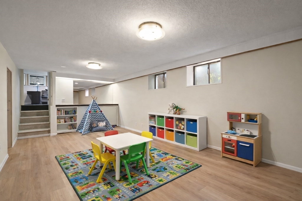 19 Selwyn Road Newton, MA 02461 - Photo 21 of 23 a living room with furniture a piano and a bookshelf