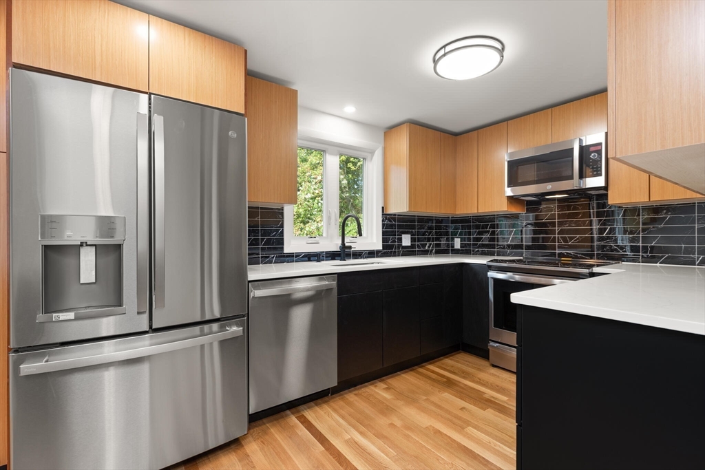 19 Selwyn Road Newton, MA 02461 - Photo 3 of 23 a kitchen with stainless steel appliances a sink stove and refrigerator