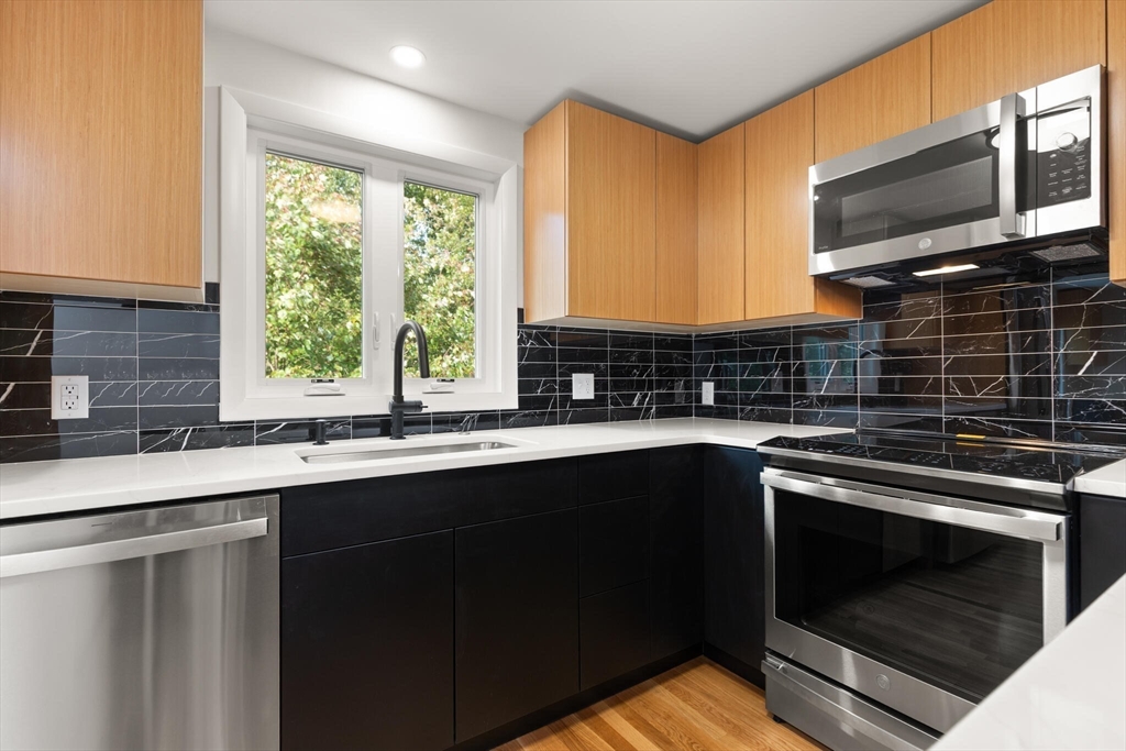 19 Selwyn Road Newton, MA 02461 - Photo 4 of 23 a kitchen with a sink stove and microwave