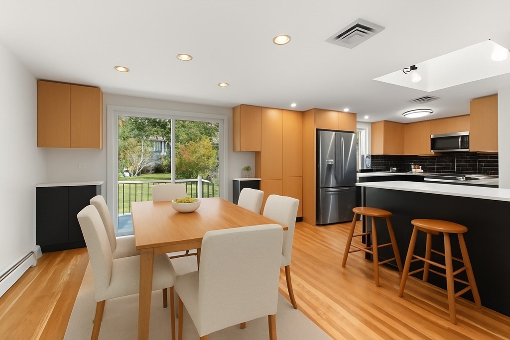 19 Selwyn Road Newton, MA 02461 - Photo 6 of 23 a dining room with furniture a kitchen view and wooden floor