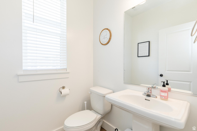 349 West 3085 South Logan, UT 84321 - Photo 11 of 37 Bright bathroom featuring a pedestal sink, wall-mounted mirror, and a window with blinds