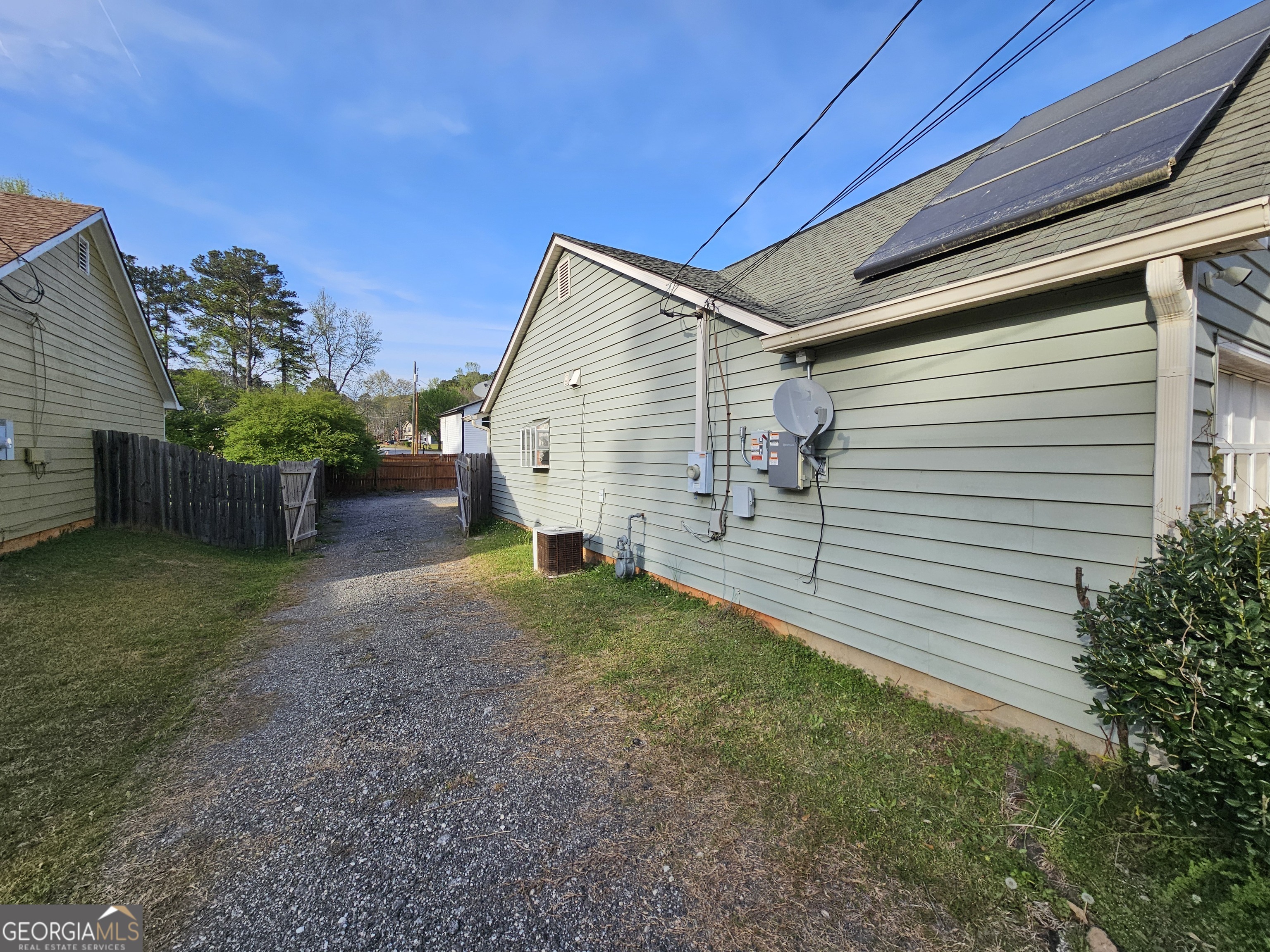 1596 Bonanza Church Road Jonesboro, GA 30236 - Photo 27 of 30 a view of backyard with potted plants and wooden fence