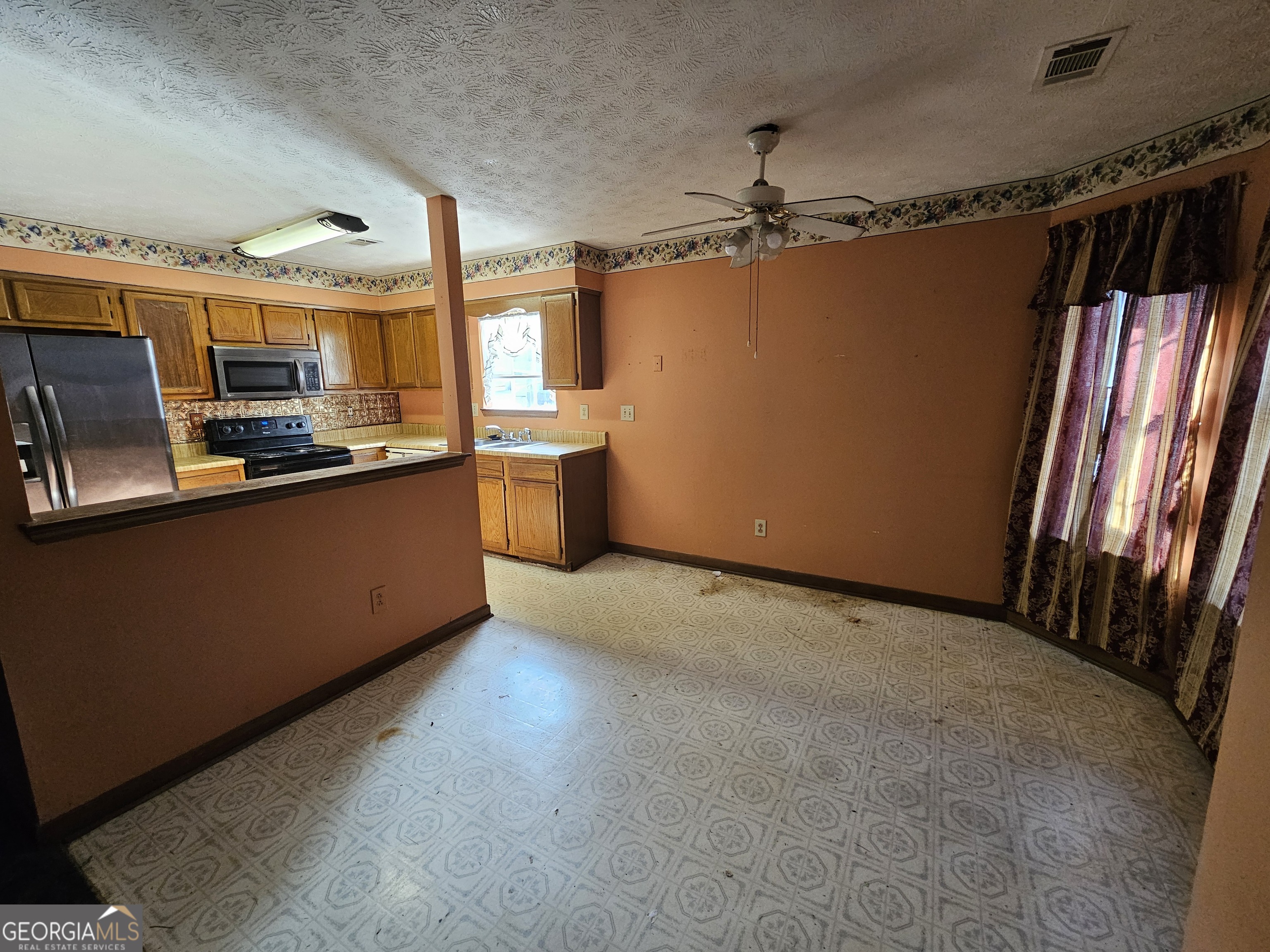 1596 Bonanza Church Road Jonesboro, GA 30236 - Photo 4 of 30 a view of a kitchen with a sink wooden floor and windows