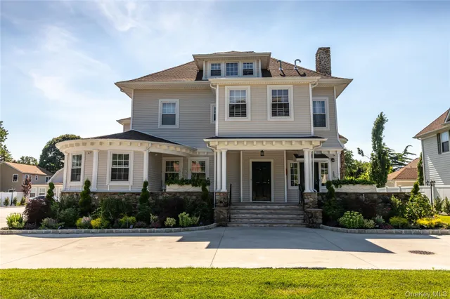 a front view of a house with yard and green space