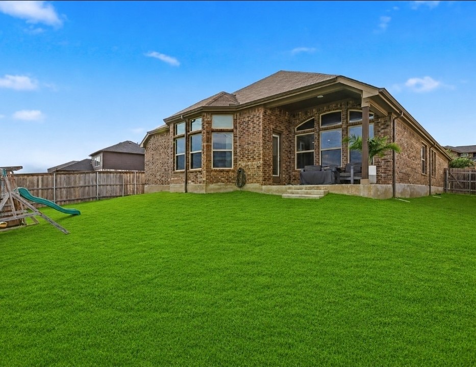 544 Cherrystone Loop Buda, TX 78610 - Photo 30 of 40 a view of a house with a yard and sitting area