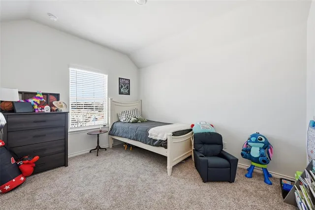 a bed room with a bed and a flat tv screen on a dresser