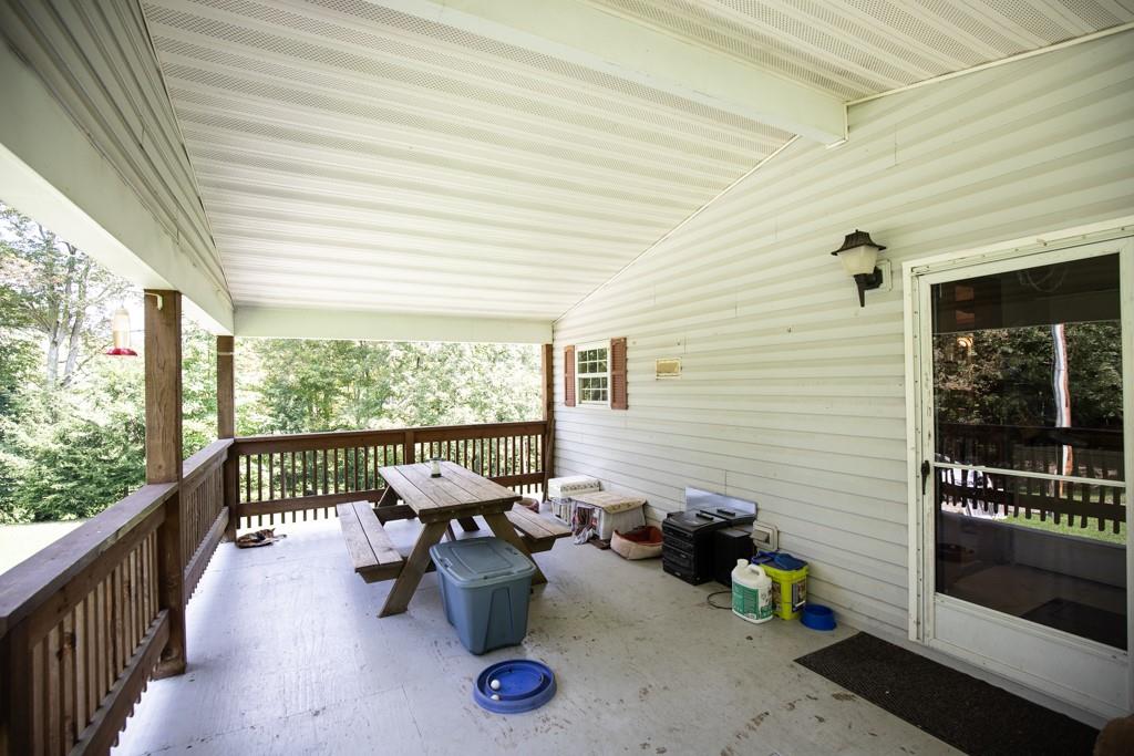 291 Bolden Road Vanderbilt, PA 15486 - Photo 3 of 12 a view of a patio with chairs and a potted plant on a table