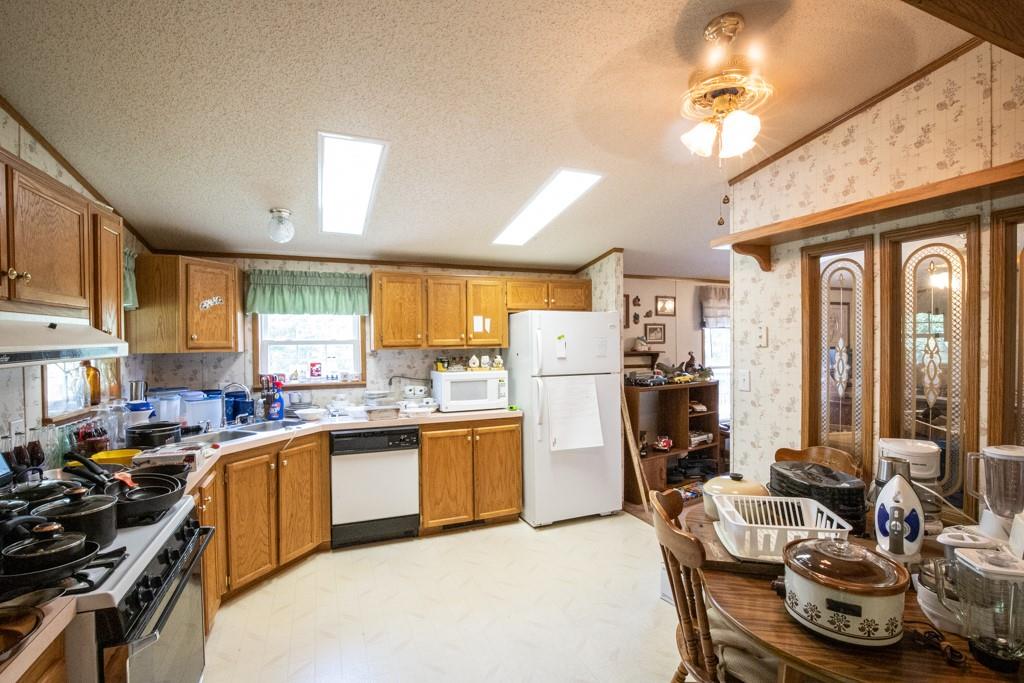 291 Bolden Road Vanderbilt, PA 15486 - Photo 4 of 12 a kitchen with a table chairs refrigerator and cabinets