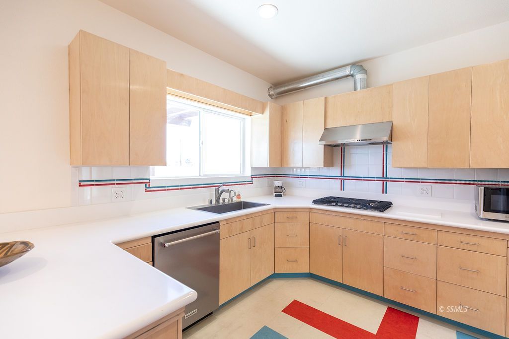 1325 Dunes Street Ridgecrest, CA 93555 - Photo 21 of 50 a kitchen with a sink cabinets and window