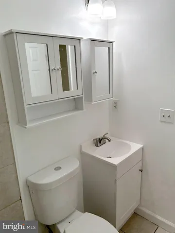 a white toilet and tub sitting next to a bathroom sink