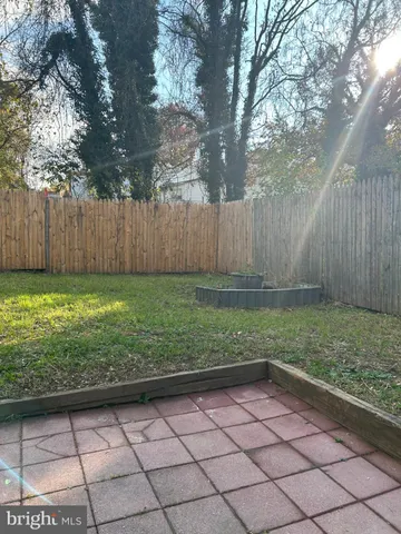 a backyard of a house with a yard and outdoor seating