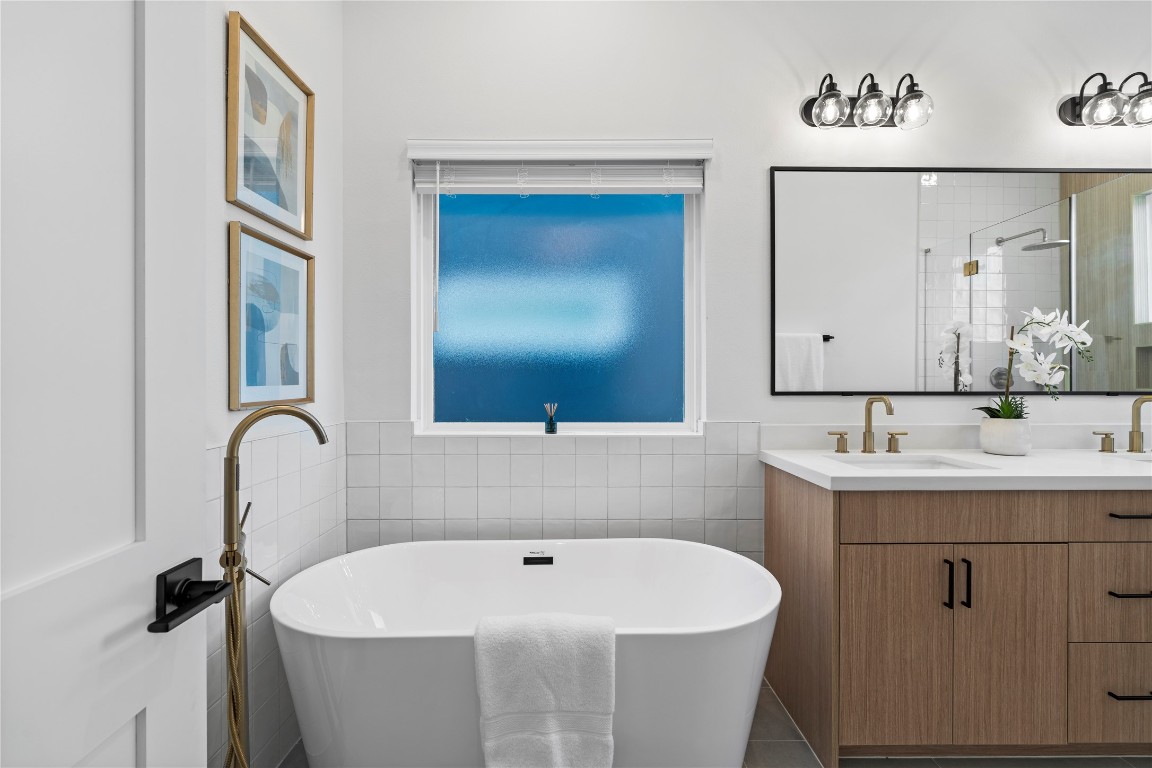 2706 Fox Street Houston, TX 77003 - Photo 22 of 39 a bathroom with a sink and mirror with bathtub