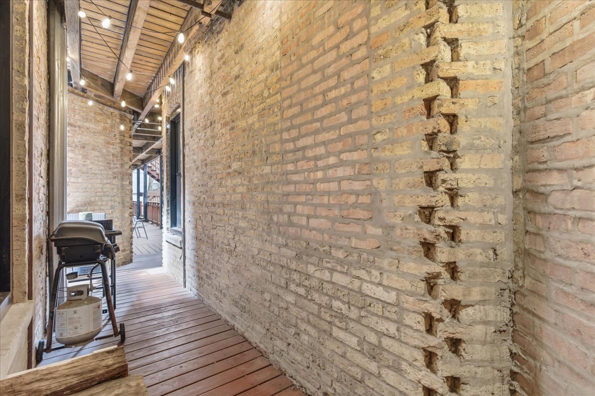 802 West George Street, Unit 1 Chicago, IL 60657 - Photo 13 of 18 a balcony with wooden floor
