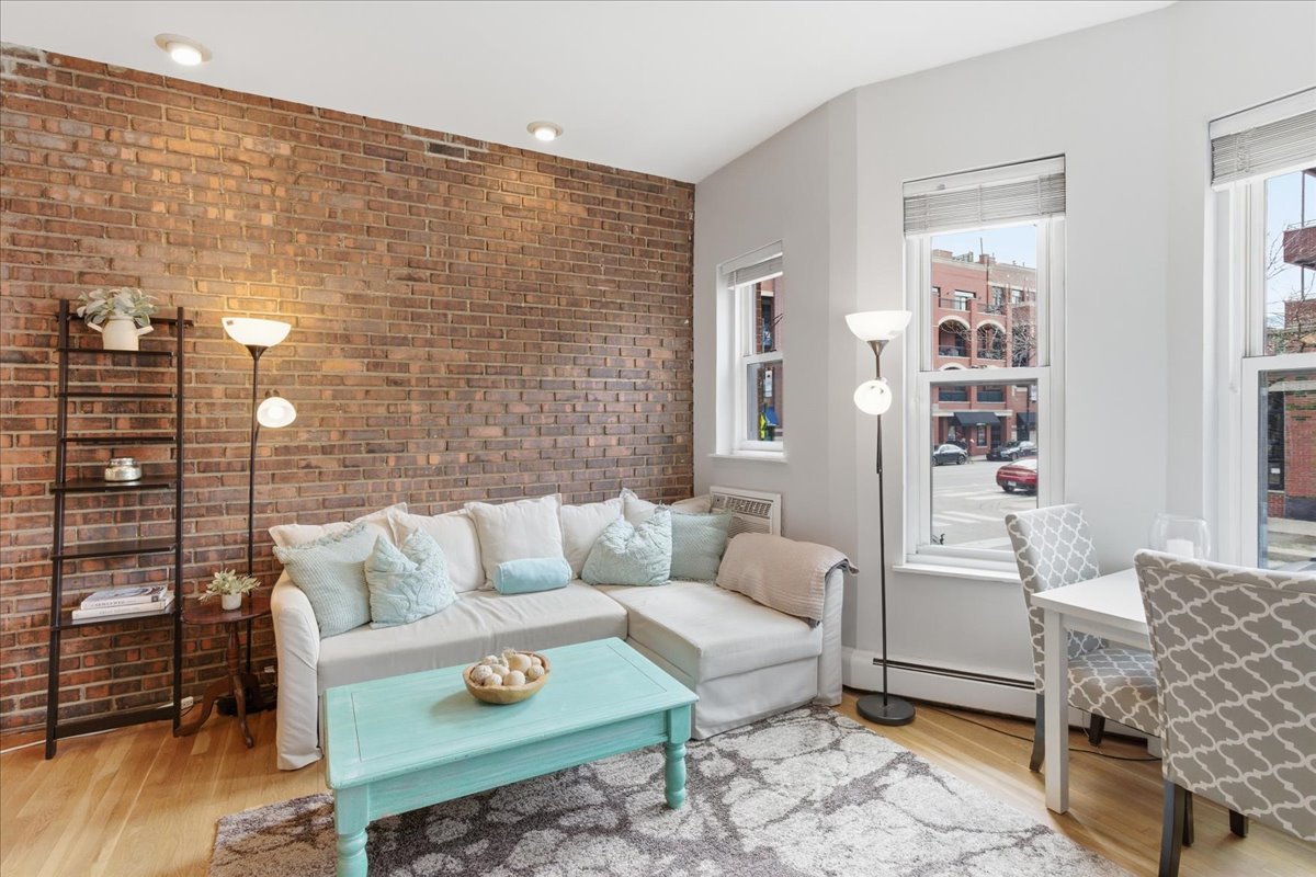 802 West George Street, Unit 1 Chicago, IL 60657 - Photo 3 of 18 a living room with furniture and wooden floor