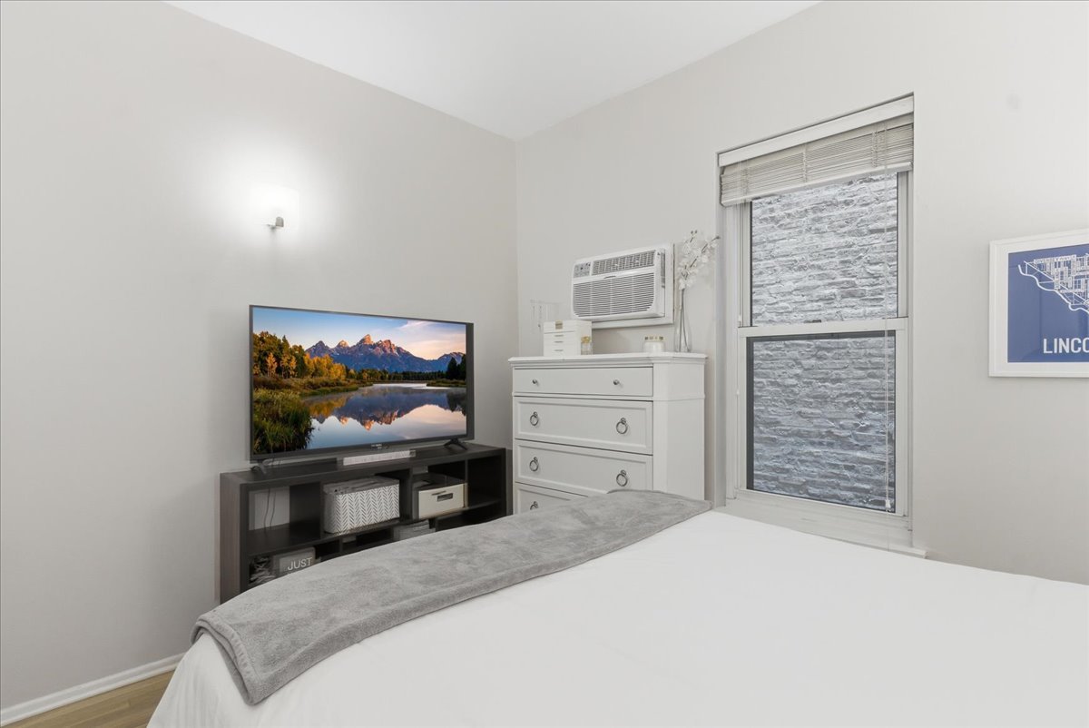 802 West George Street, Unit 1 Chicago, IL 60657 - Photo 8 of 18 a bedroom with a bed and a flat screen tv