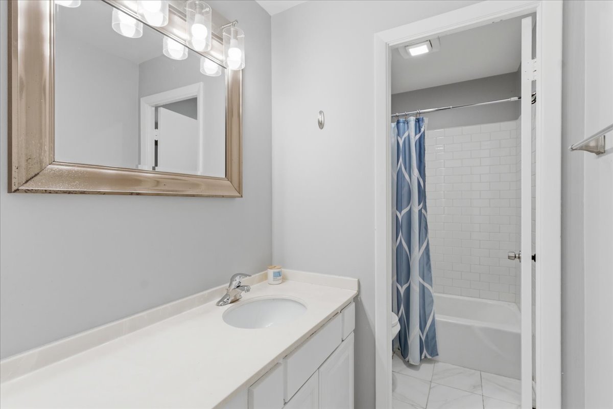802 West George Street, Unit 1 Chicago, IL 60657 - Photo 9 of 18 a bathroom with a sink and mirror