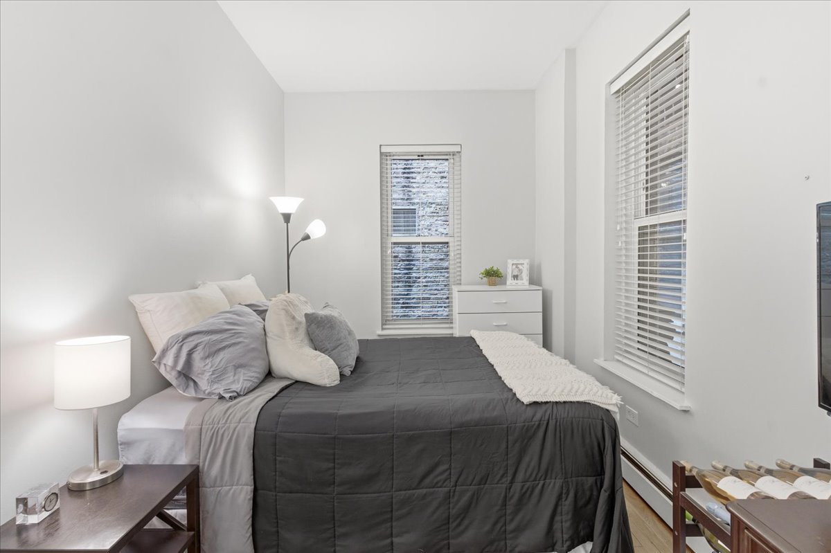 802 West George Street, Unit 1 Chicago, IL 60657 - Photo 10 of 18 a bedroom with a bed and a window