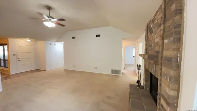 a view of a livingroom with a ceiling fan a ceiling fan and a bathroom