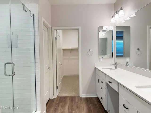 a bathroom with a glass shower door