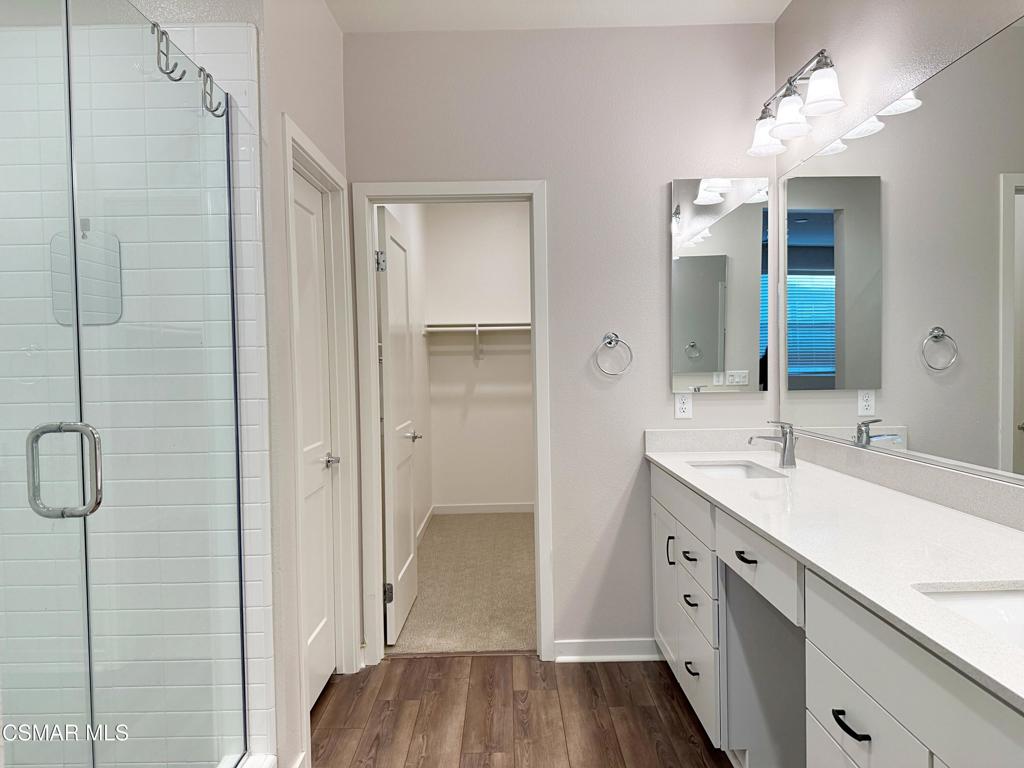 215 Red Brick Drive, Unit 5 Simi Valley, CA 93065 - Photo 13 of 30 a spacious bathroom with a double vanity sink a mirror and shower