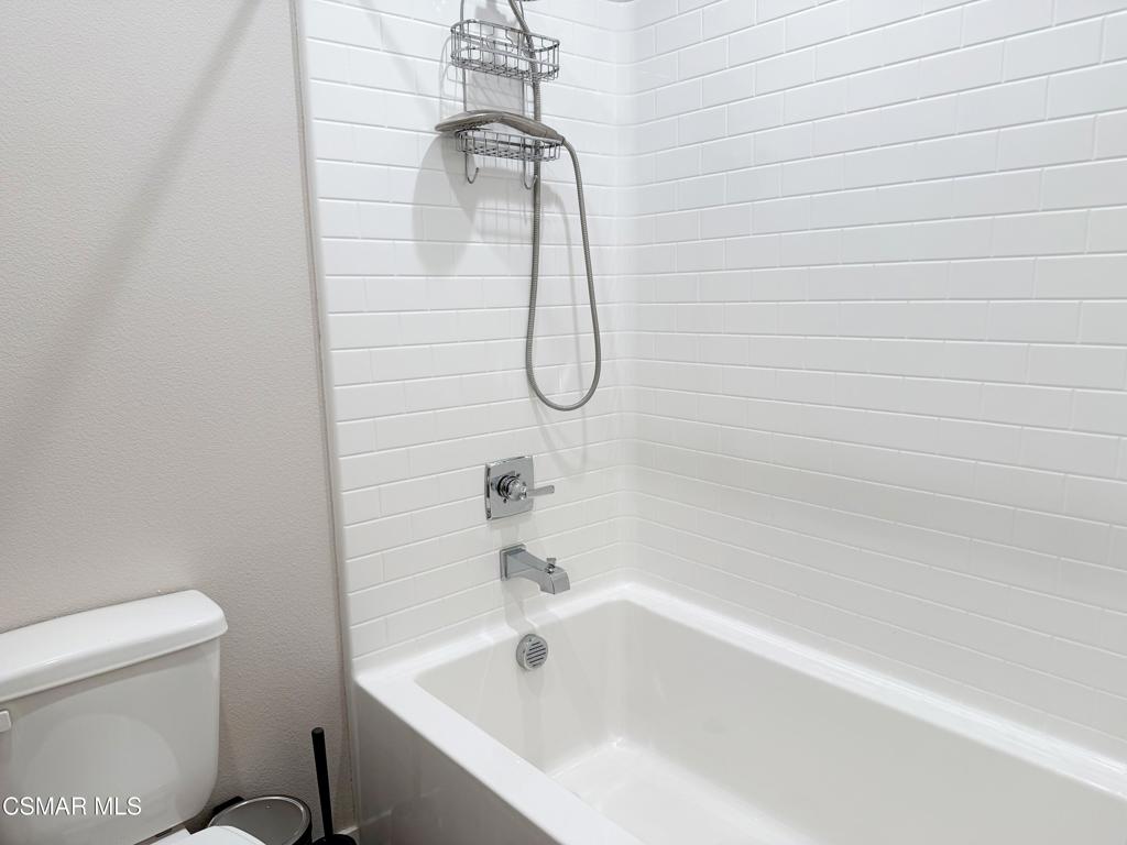 215 Red Brick Drive, Unit 5 Simi Valley, CA 93065 - Photo 19 of 30 a bathroom with a white bath tub and a shower