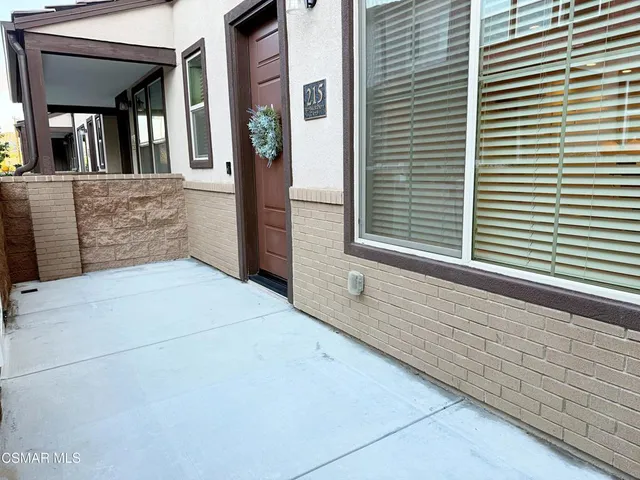 a view of kitchen with kitchen island granite countertop stainless steel appliances refrigerator and microwave