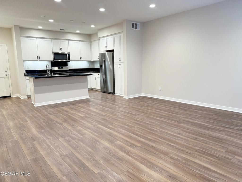 215 Red Brick Drive, Unit 5 Simi Valley, CA 93065 - Photo 3 of 30 a view of kitchen with kitchen island granite countertop stainless steel appliances refrigerator and microwave