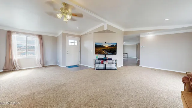 a view of livingroom with furniture and chandelier fan