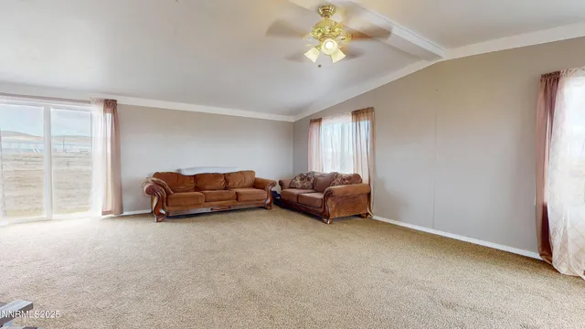 a living room with furniture a chandelier and a window