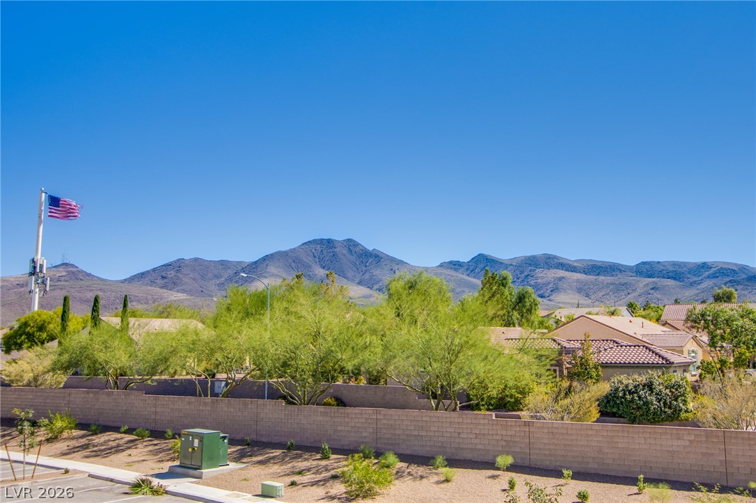 2555 Hampton Road, Unit 8201 Henderson, NV 89052 - Photo 14 of 33 Majestic mountain ridges rise high above a peaceful residential neighborhood under clear blue skies.