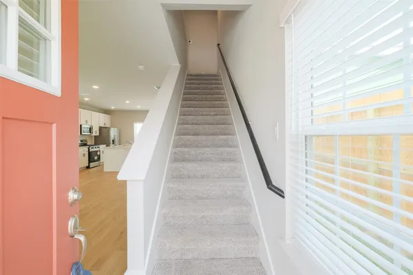 a view of entryway and hall with wooden floor