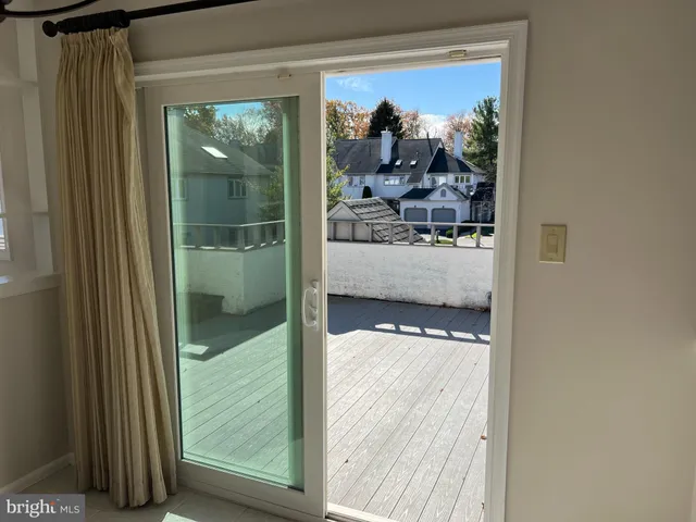 a view of a glass door with a balcony from a room