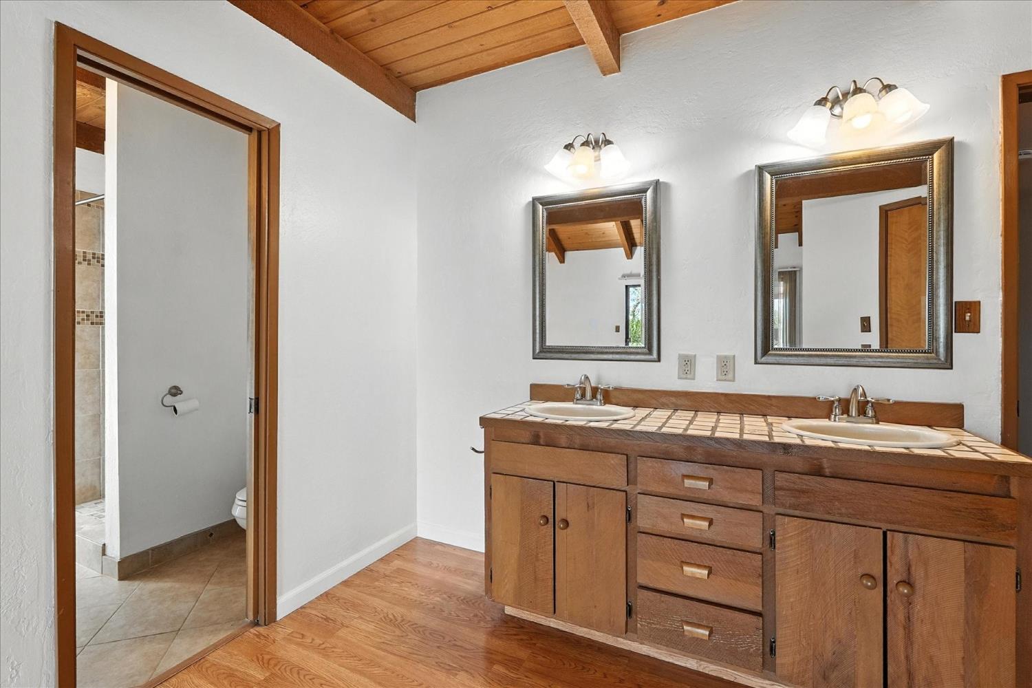 42480 Ranger Cir Way Coarsegold, CA 93614 - Photo 20 of 40 a bathroom with a double vanity sink and a mirror