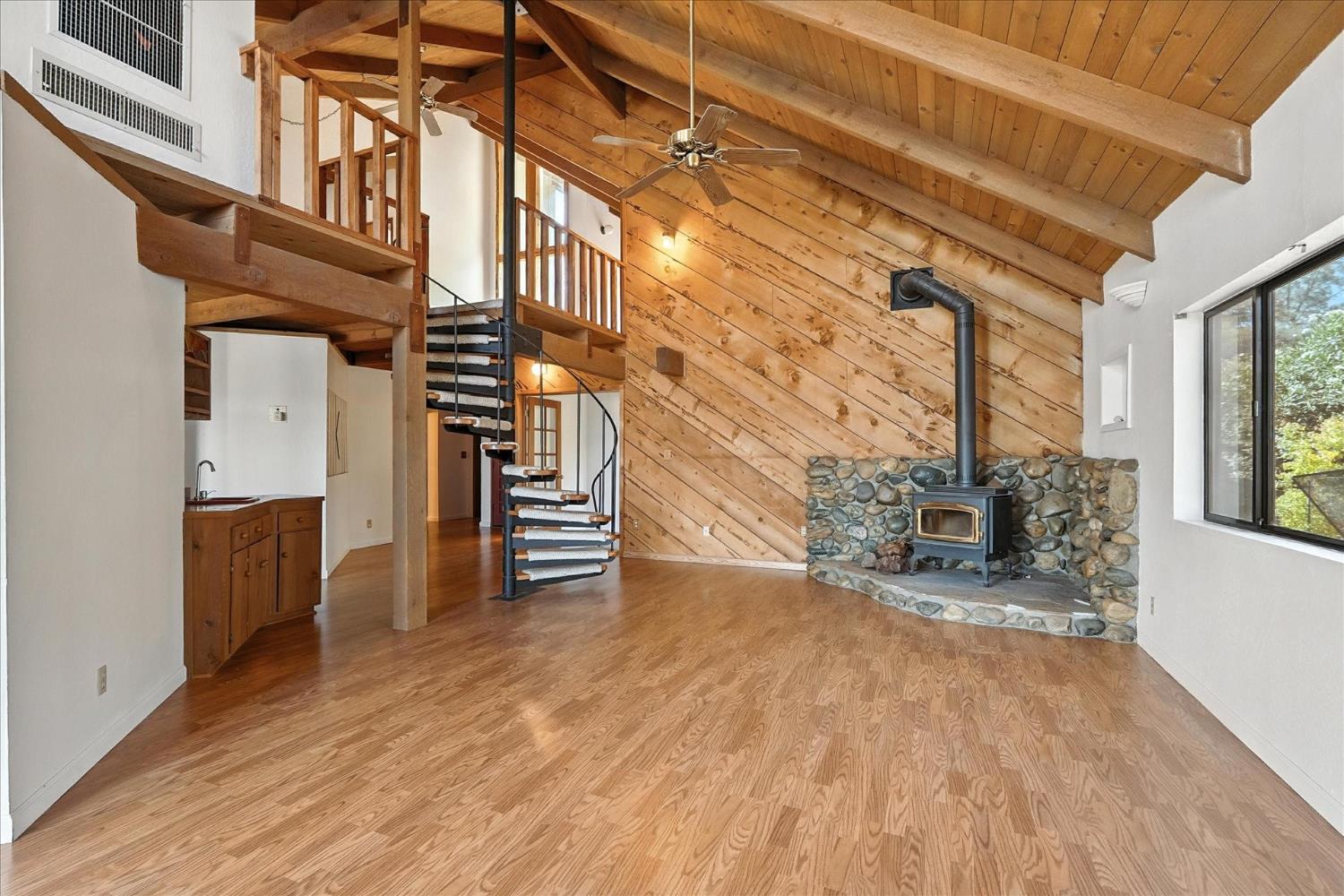 42480 Ranger Cir Way Coarsegold, CA 93614 - Photo 4 of 40 a view of an empty room with wooden floor and stairs