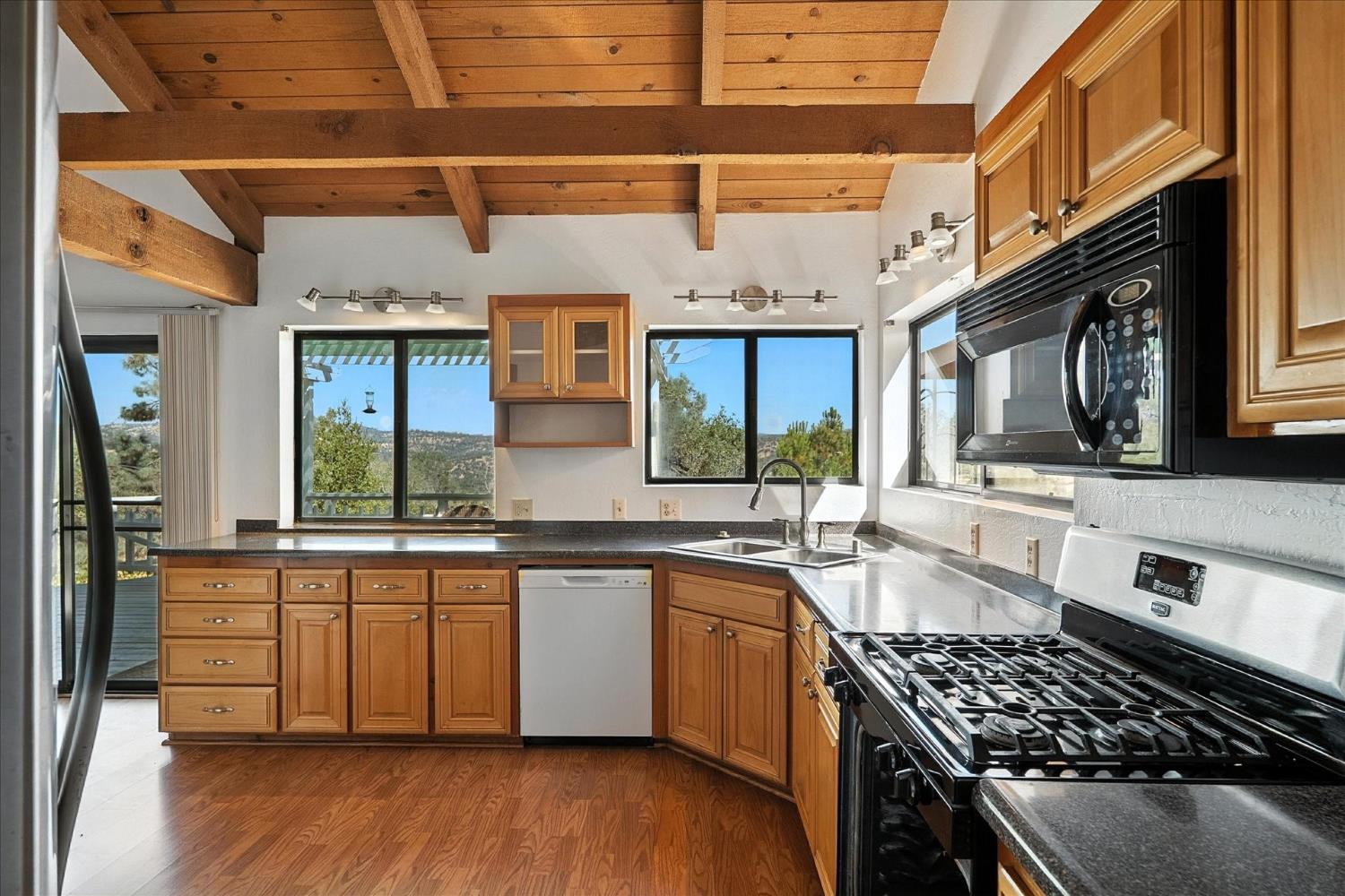 42480 Ranger Cir Way Coarsegold, CA 93614 - Photo 9 of 40 a kitchen with stainless steel appliances a sink a stove and cabinets