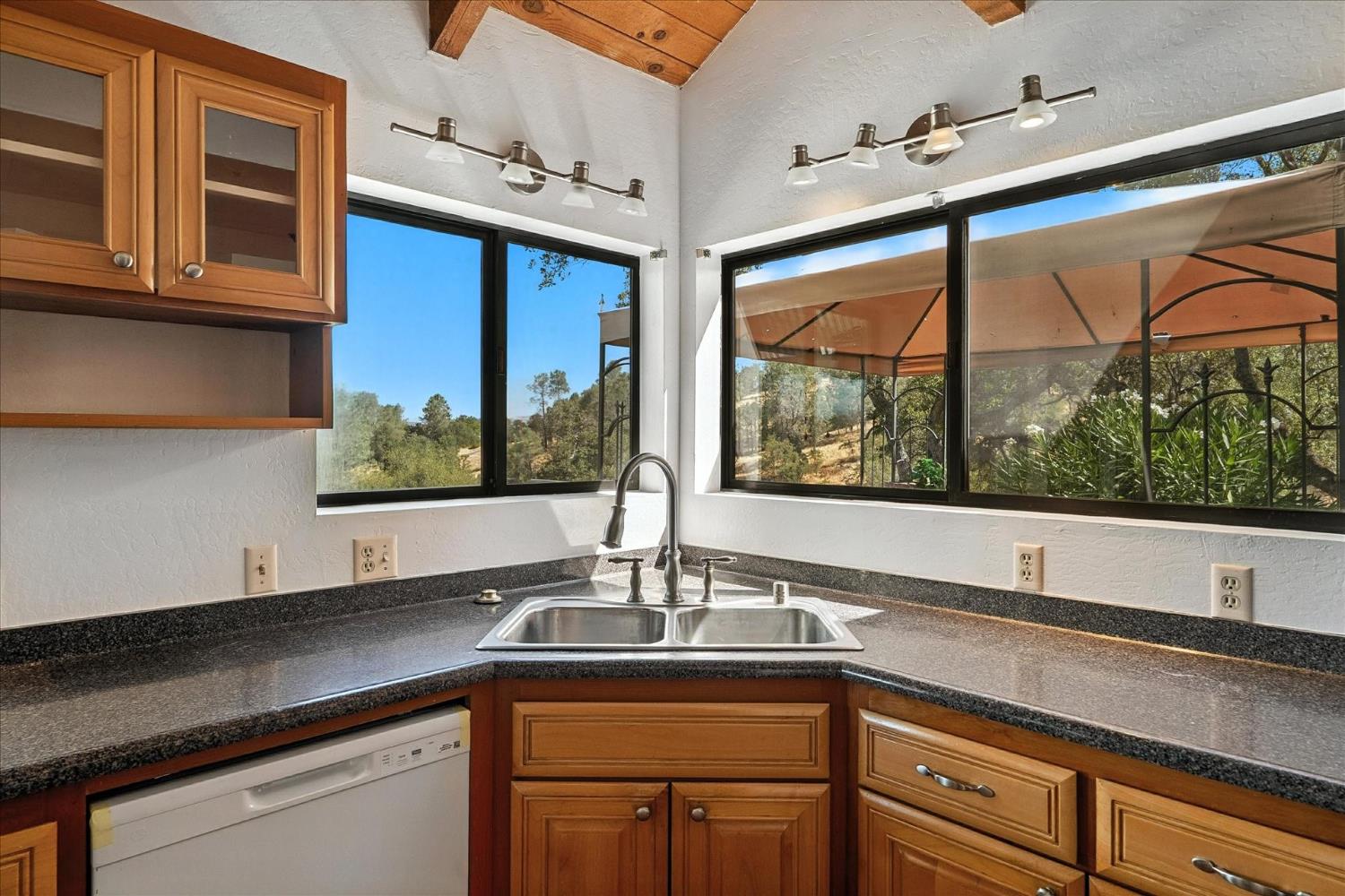 42480 Ranger Cir Way Coarsegold, CA 93614 - Photo 10 of 40 a kitchen with stainless steel appliances granite countertop a sink window and cabinets