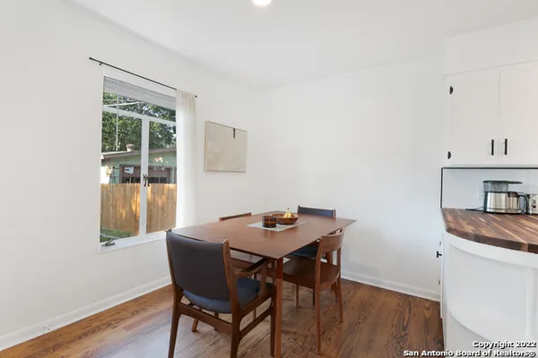 a dining room with furniture and window