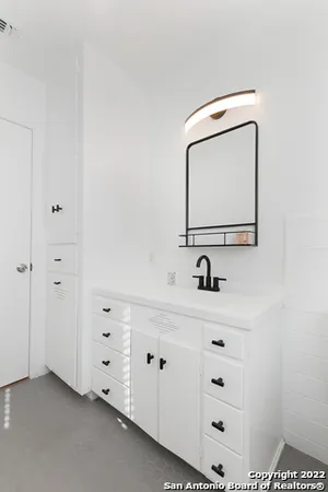 a bathroom with a sink vanity and mirror