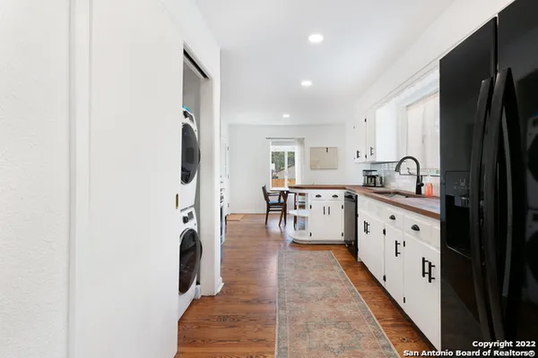 a kitchen with stainless steel appliances granite countertop a refrigerator and a stove