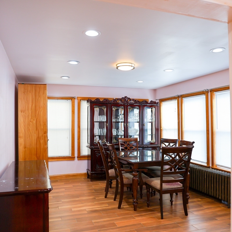 186 Powell Street Lowell, MA 01851 - Photo 14 of 42 a view of a dining room with furniture and wooden floor